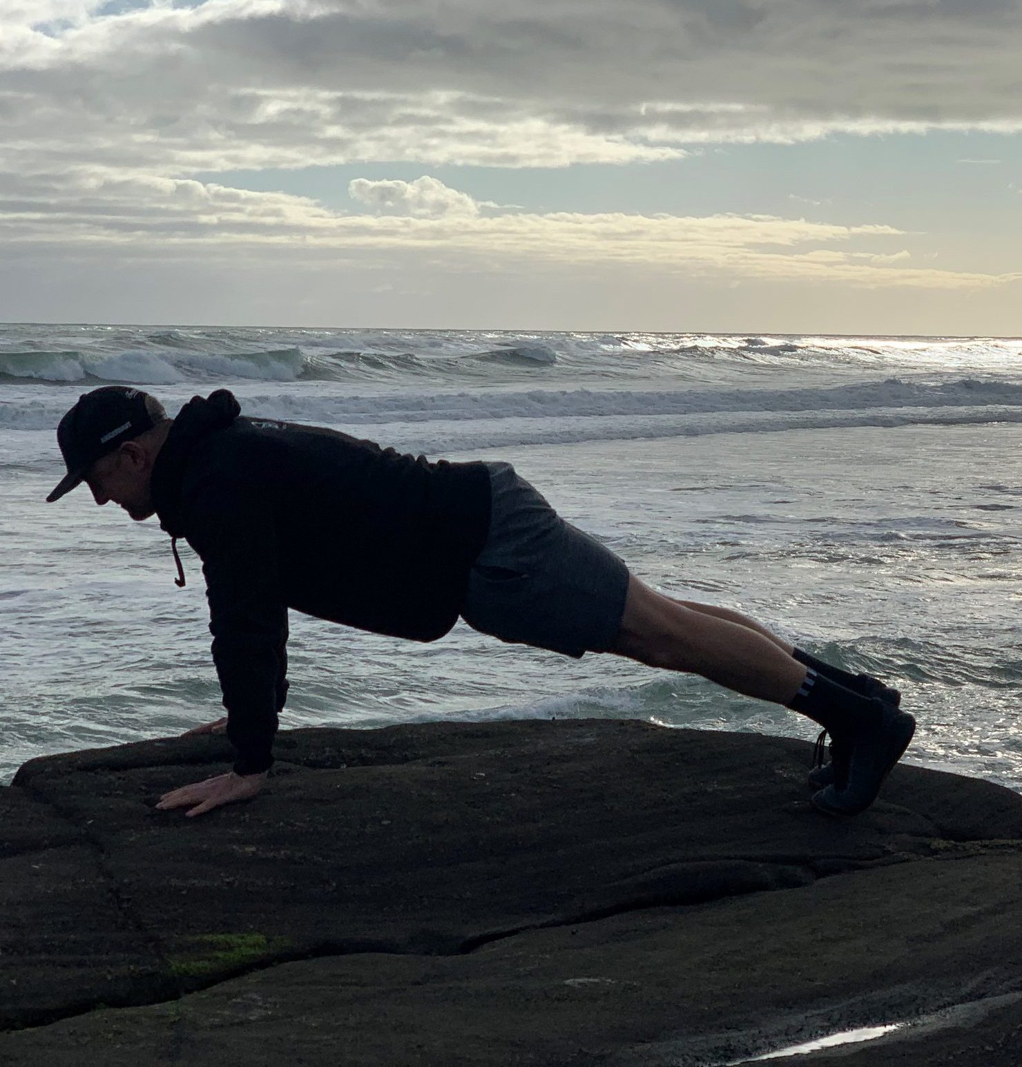 Man over 40 doing some body weight training as part of online fitness programme